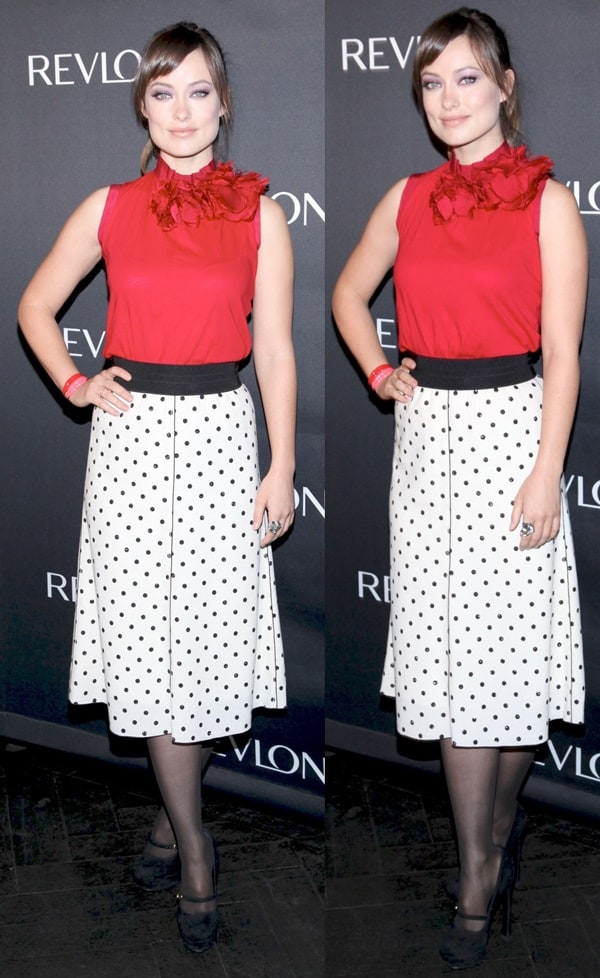 Olivia Wilde channels retro glam in a red Lanvin rosette-adorned blouse and a polka-dotted Marc Jacobs skirt, paired with classic black YSL Mary Jane heels