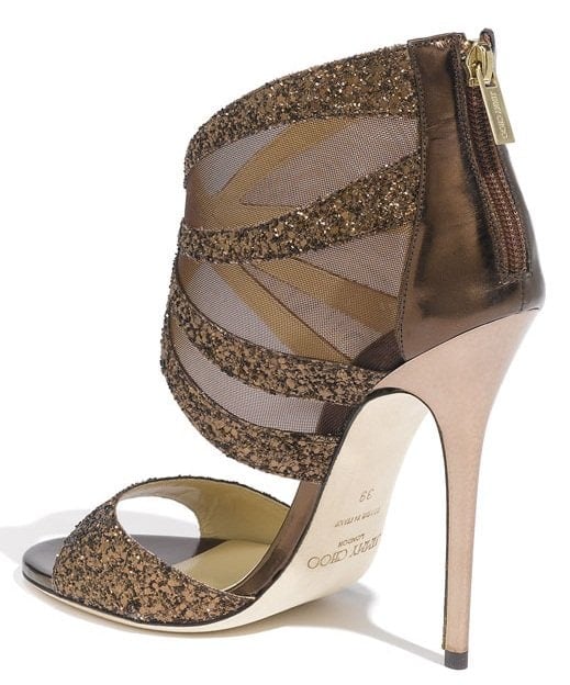 Chunky glitter illuminates the curvy straps of a glamorous high-heel sandal with tonal mesh panels for added allure