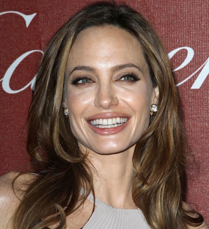 Angelina Jolie shows off her earrings with softly tousled hair