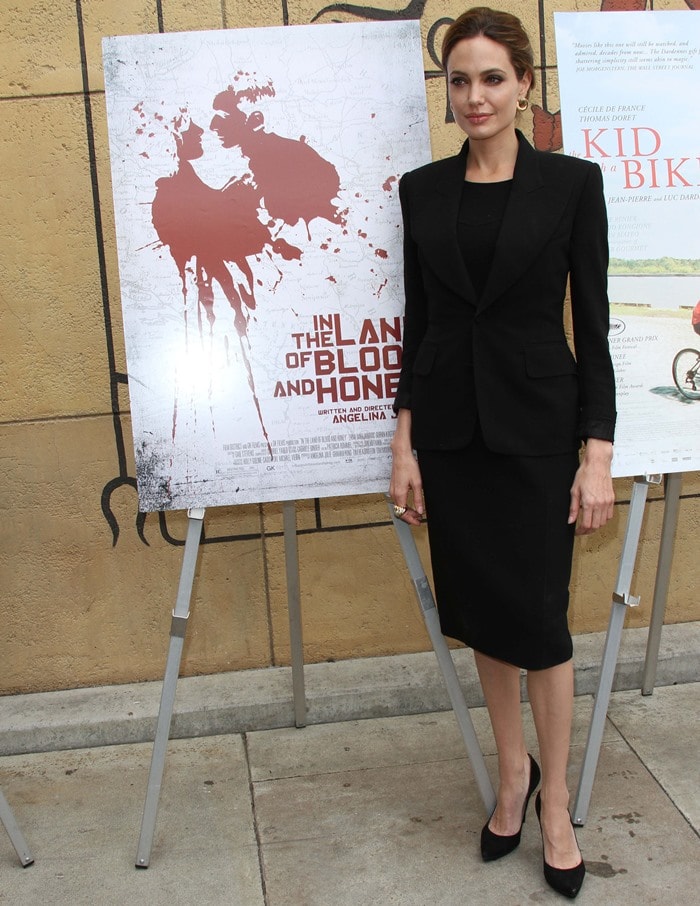 Angelina Jolie masters monochrome elegance in a sleek black skirt suit, paired with classic pointed-toe pumps for a polished yet understated red carpet look