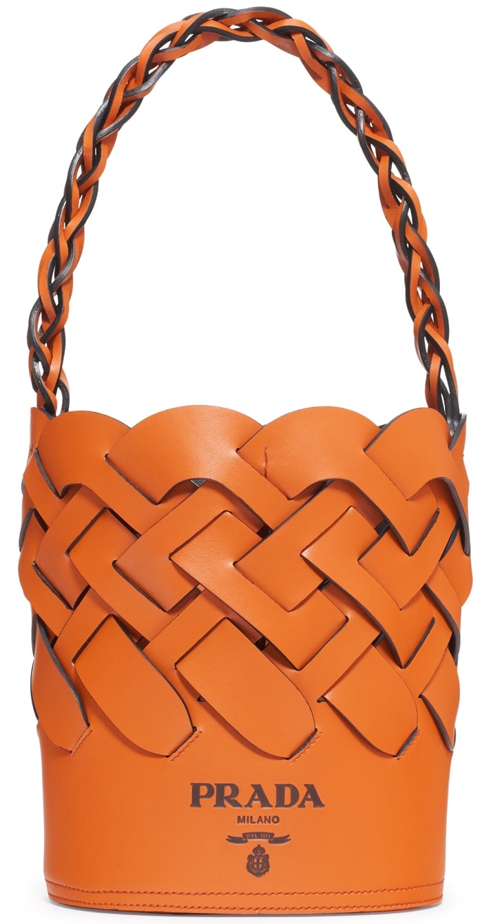 A woven design gives a distinctive look to a bucket Prada bag crafted in Italy of exceptionally soft and lustrous calfskin with a tethered zip pouch inside