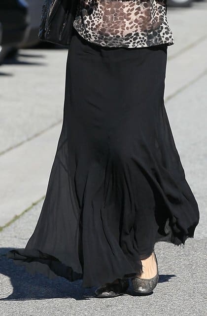Pregnant Molly Sims wears a black maxi skirt