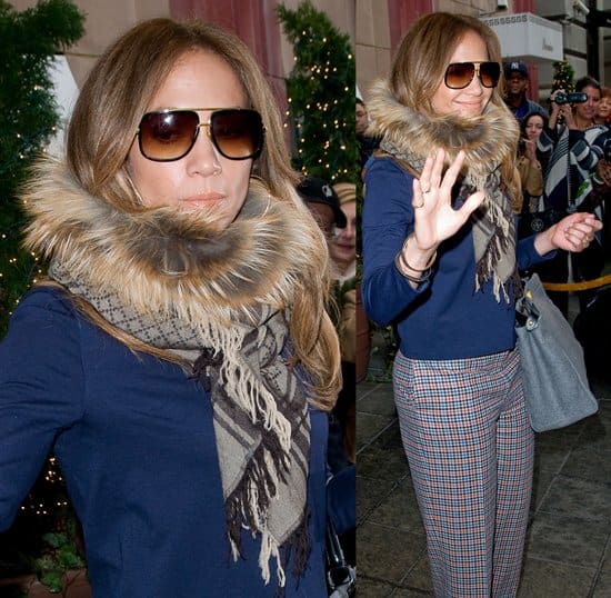 Jennifer Lopez was spotted leaving her hotel in NYC on February 1, 2012, wearing Dior Guetre lace-up leather and crocodile print ankle boots, The Row Nola pants, a Fendi Peekaboo satchel in grey jersey, and a Gucci fox-trimmed GG patterned stole in taupe
