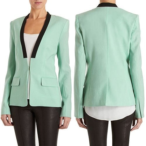 Blazer with mock lapel in a contrasting black color, flap pockets, and an interesting slit detail at the cuffs of the sleeves