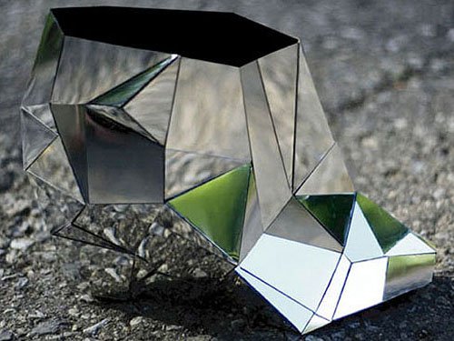 These invisible shoes are wedge ankle booties that use mirrors to reflect their surroundings, creating the illusion of invisibility