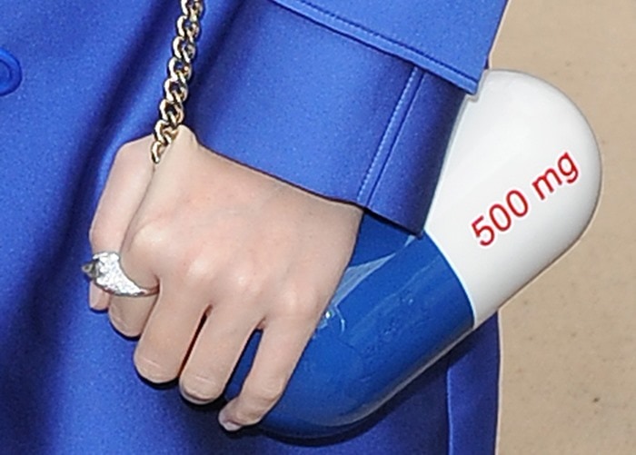 Katy Perry carries a blue pill-shaped "Pilule" clutch bag from Christian Louboutin