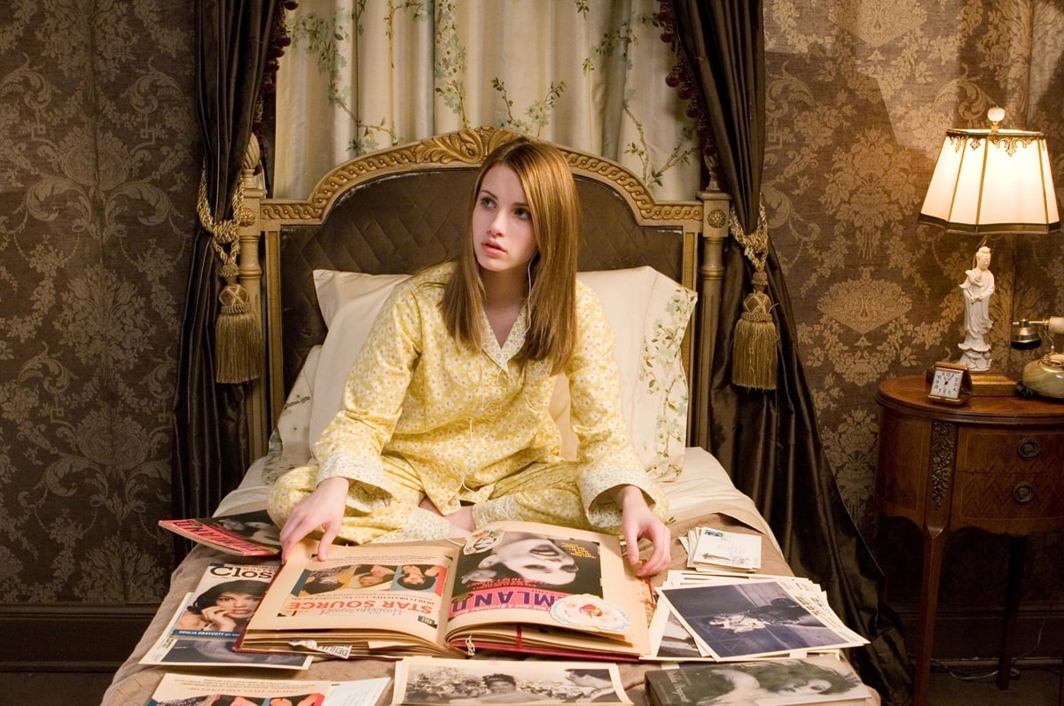 Emma Roberts as Nancy Drew, surrounded by clues and case files, wearing pajamas in a scene from the 2007 mystery thriller