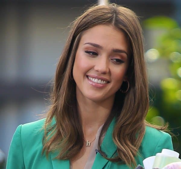 Jessica Alba wears a delicate hand-sculpted gold “h” pendant necklace made of solid matte-finished 14-karat yellow gold by jeweler Alex Woo