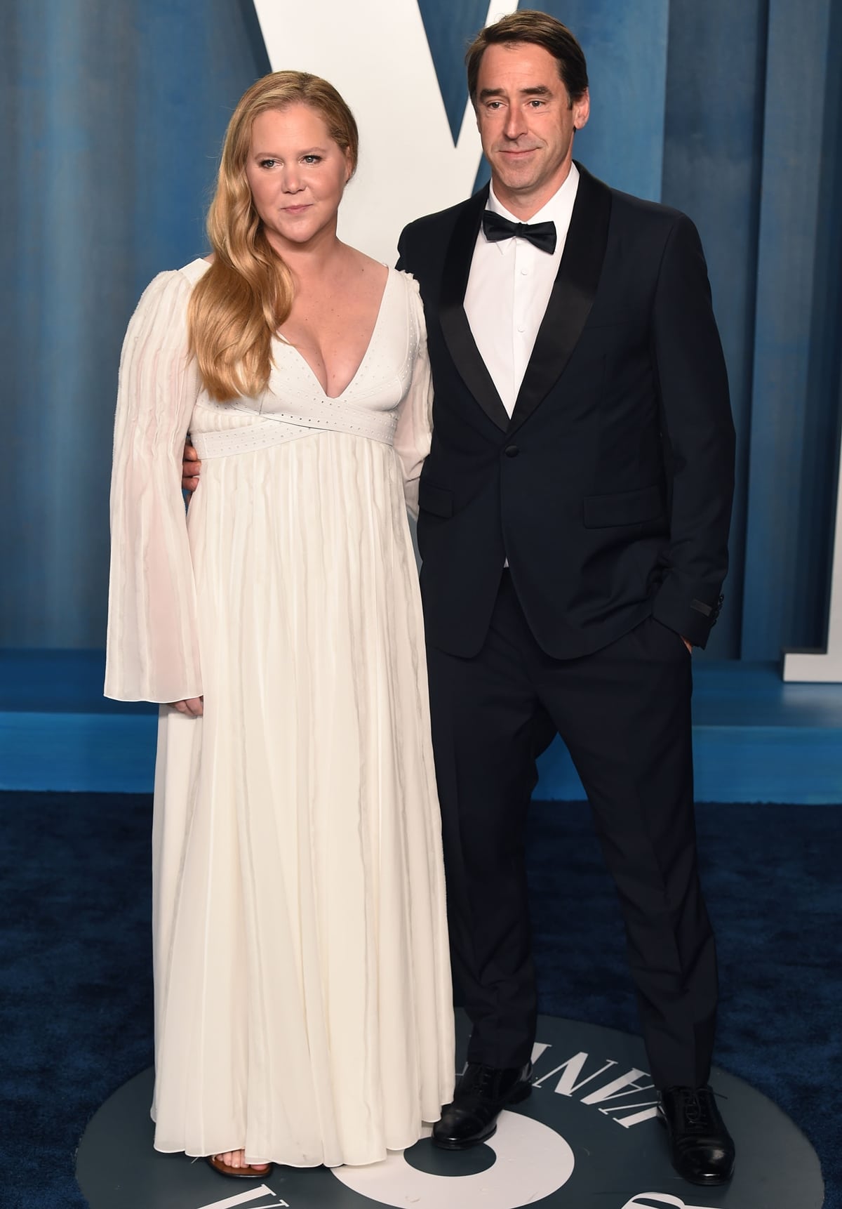 Amy Schumer in a silk Chloé gown and her husband Chris Fischer attend the 2022 Vanity Fair Oscar Party