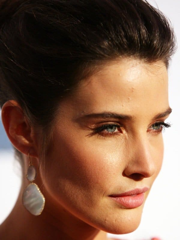 Accessorizing with Elegance: Cobie Smulders wearing statement earrings, complementing her glamorous ensemble at the Tribeca Film Festival