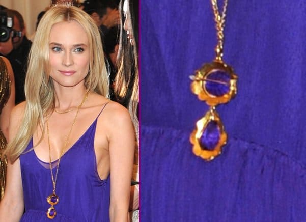 Diane Kruger wears a gold necklace with purple stones at the "Schiaparelli And Prada: Impossible Conversations" Costume Institute Gala