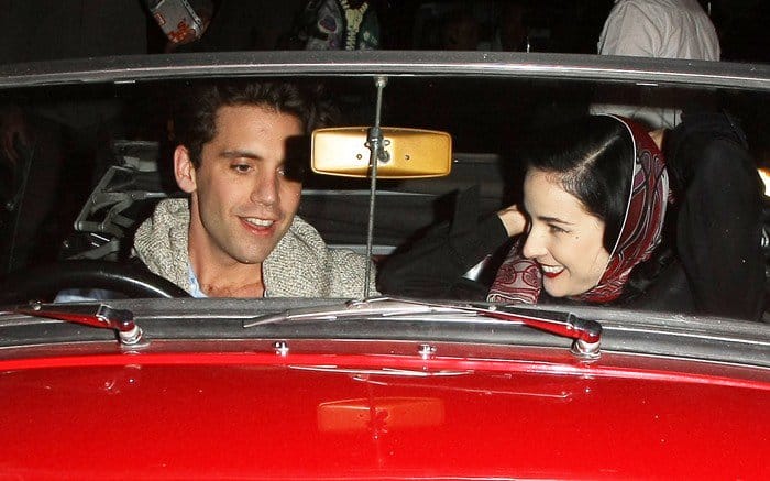 British singer Mika and Dita Von Teese leave the Arts Club together in a red vintage car in London