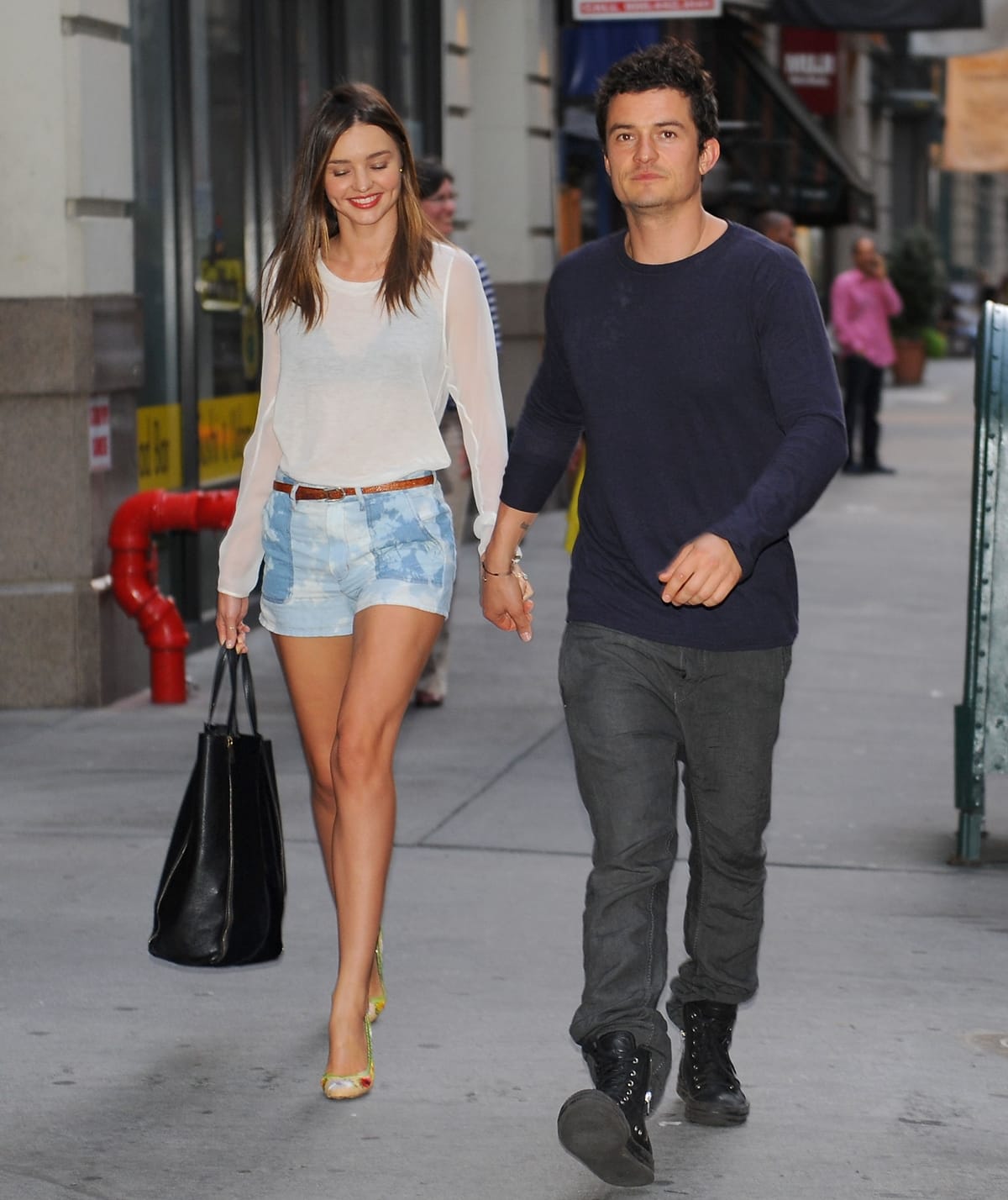 On June 25, 2012, in New York City, Miranda Kerr was seen holding hands with Orlando Bloom, looking chic in Isabel Marant Marcel tie-dye cotton shorts, an Equipment sleeveless signature blouse, Lanvin puffy gladiator sandals, accessorized with Miu Miu Culte sunglasses, a Longines LA Grande Classique ultra-slim alligator strap watch, and a Celine leather zipper detail tote