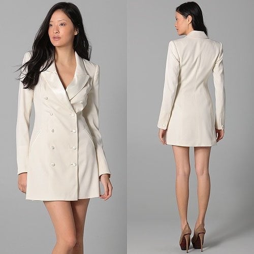This wool tuxedo dress features satin trim and a notched collar. 4-button closure at double-breasted detail.