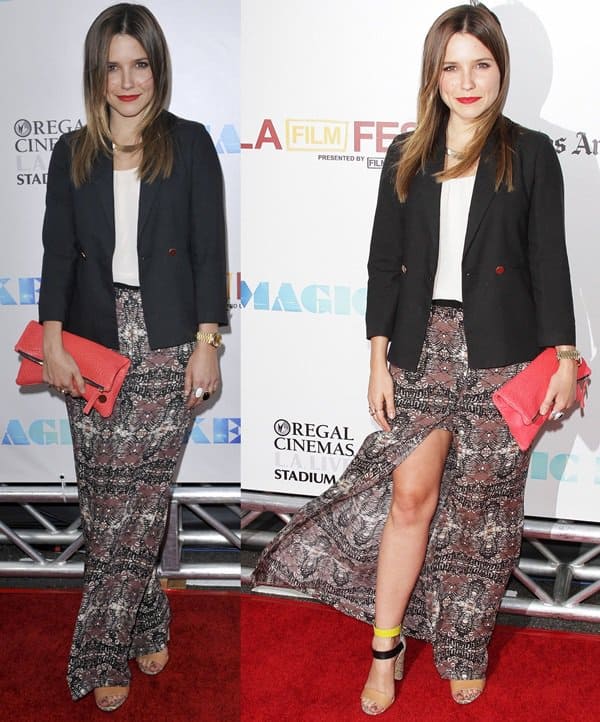 Sophia Bush brings effortless chic to the red carpet in a tailored black blazer over a flowing batik-print maxi skirt, complemented by a bold red clutch and strappy heels at the Magic Mike premiere