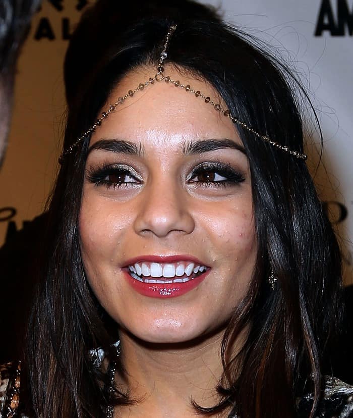 Vanessa Hudgens elegantly accents her ensemble with a Haute Betts Madam Headpiece, bringing a touch of bohemian sophistication to her look at the 'Sucker Punch' event in Las Vegas