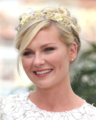 Kirsten Dunst in a white D&G dress and bejeweled flower tiara at her Cannes Film Festival debut