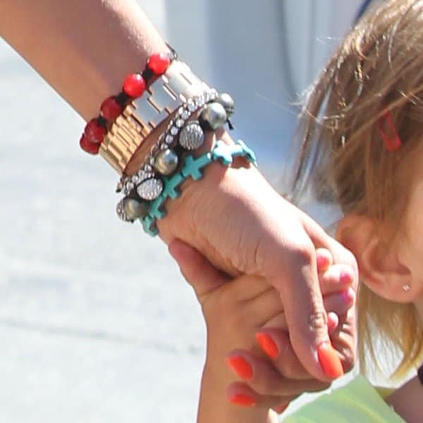 A closer look at Alessandra Ambrosio's vibrant bead bracelets, adding a splash of color and personality to her chic ensemble