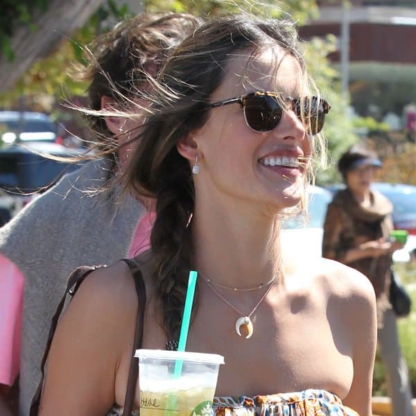 Alessandra Ambrosio complements her stylish look with a Jacquie Aiche double bone horn necklace, paired gracefully with assorted colorful bead bracelets