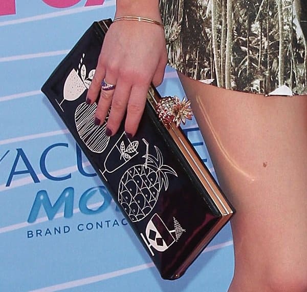 Accessorizing her outfit, Carly Rae Jepsen carries the eye-catching Kate Spade 'Tiki-Bar' clutch, a perfect blend of style and whimsy
