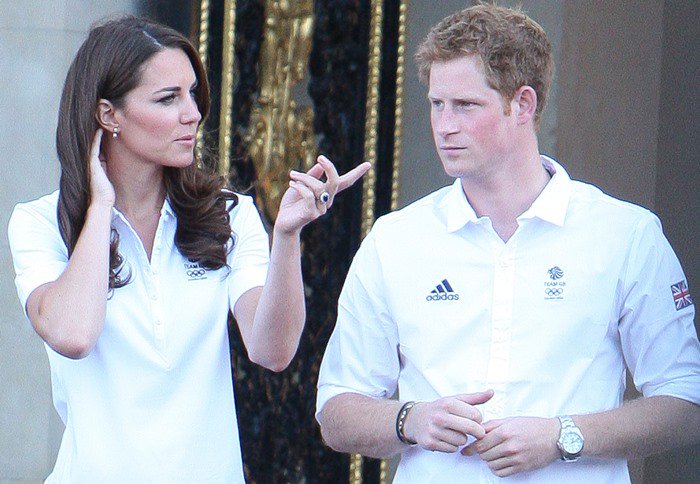 Catherine, Duchess Of Cambridge, and Prince Harry greet the Olympic torch
