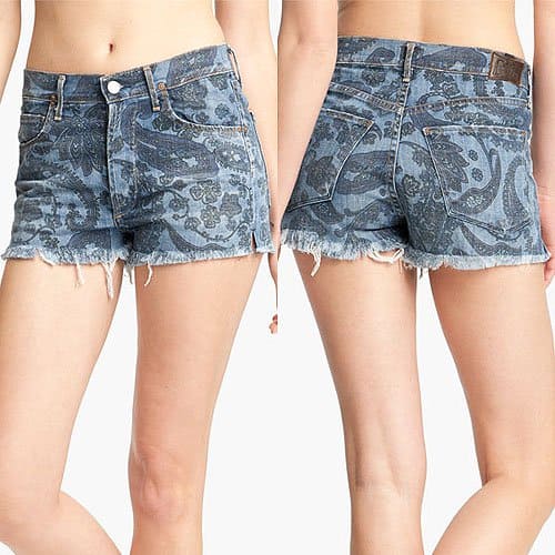 These printed high-waisted white denim shorts feature 5-pocket styling and a button fly