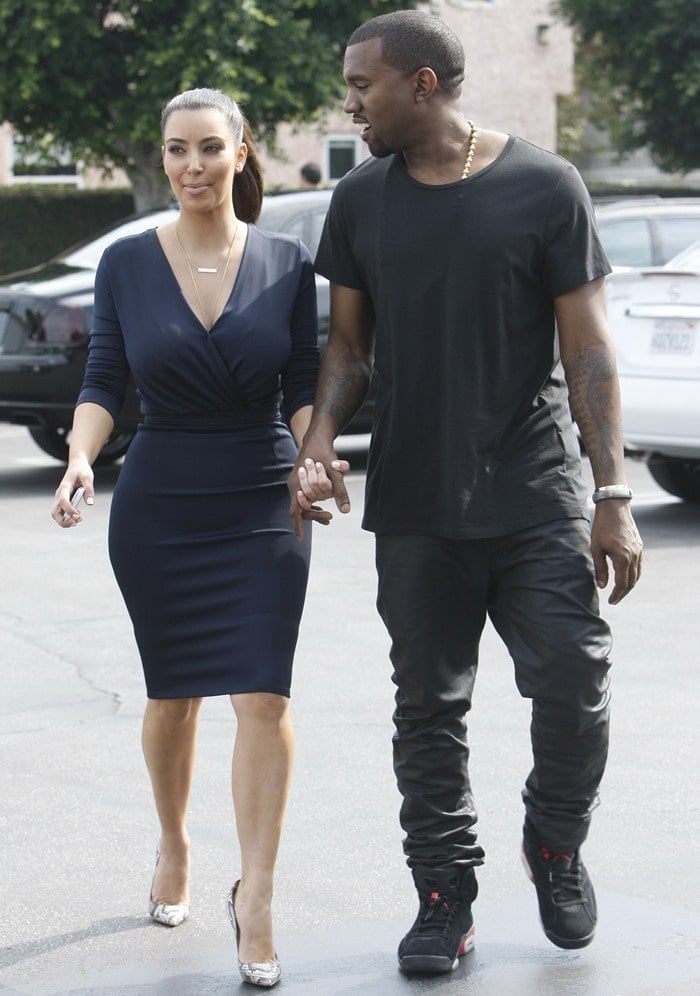 Kim Kardashian and Kanye West attended the opening of the Kardashian's newest DASH store looking very close and cuddly