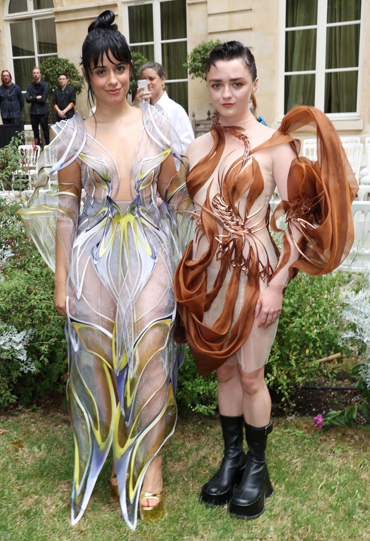 Maisie Williams and Camila Cabello, elegantly draped in Iris van Herpen's latest creations, grace the Fall/Winter 2023/2024 Haute Couture runway at Paris Fashion Week on July 3, 2023, in Paris, France