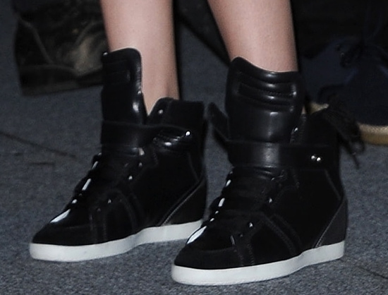 Kristen Stewart adds a few inches to her height in black leather Barbara Bui wedge heel sneakers