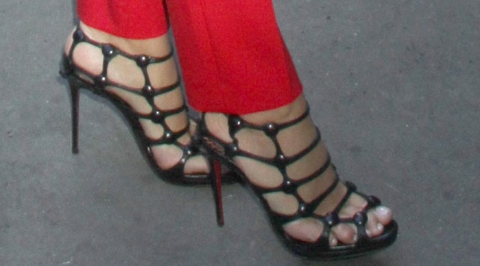 Blake Lively showcases a flawless pedicure in bold black Christian Louboutin “Neuron” cage heels, adding edge to her striking red suit