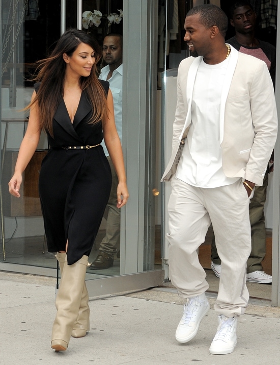 Kim Kardashian and Kanye West looking at each other as they leave a building to go shopping in Soho New York City on September 2, 2012