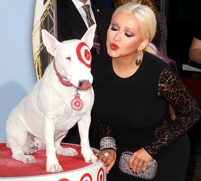 Christina Aguilera getting ready to kiss a dog