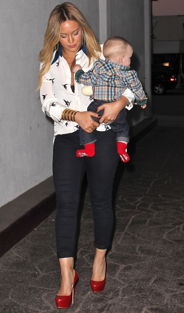 Hilary Duff celebrates her 25th birthday in Beverly Hills, pairing a chic printed blouse and dark cropped skinny jeans with bold red Christian Louboutin "Bianca" pumps for a stylish, effortless look