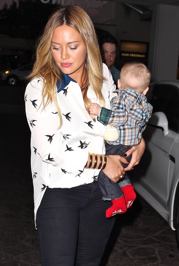 Hilary Duff wears her hair down and carries her son, Luca, as she celebrates her birthday