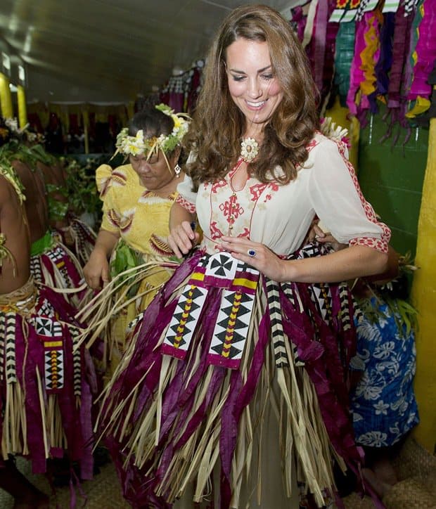 The Duchess of Cambridge danced in Tuvalu wearing an Alice by Temperley 'Beatrice' cream crepe maxi dress with red and beige embroidery, a keyhole neckline, and a traditional grass skirt and floral headdress