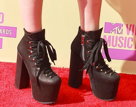 Kreayshawn flaunts her sexy legs in black boots