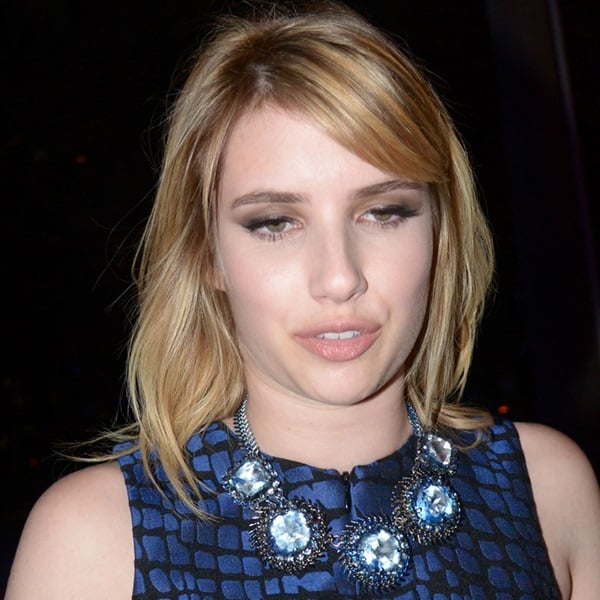 Close-up of Emma Roberts' elegant statement necklace, a perfect accessory for her midnight blue ensemble