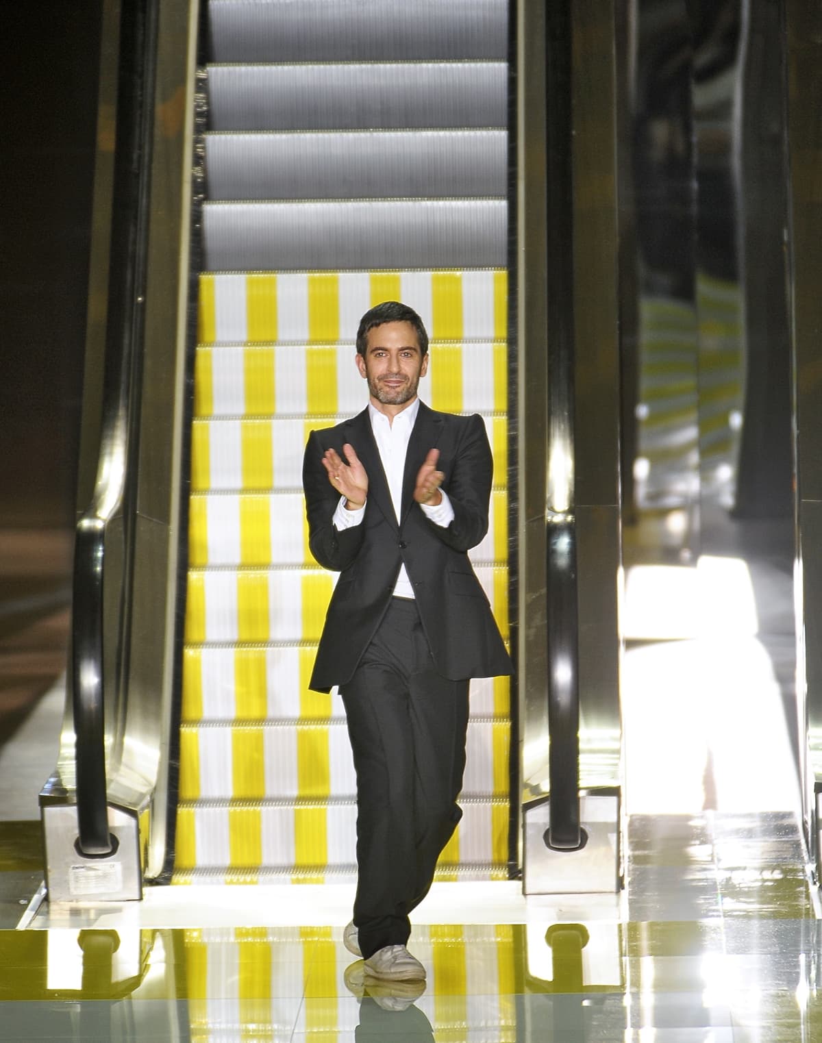 Fashion designer Marc Jacobs acknowledges the applause of the audience after the Louis Vuitton Spring/Summer 2013 show