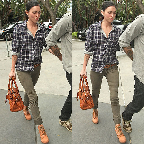 Megan Fox holds on to Brian Austin Green as they arrive at the Staples Center for the Los Angeles Lakers against Denver Nuggets NBA basketball game in Los Angeles, CA on April 3, 2011