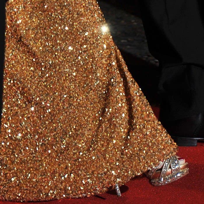 Penélope Cruz stuns in glittering platform sandals paired with her dazzling gold L'Wren Scott gown at the Skyfall premiere