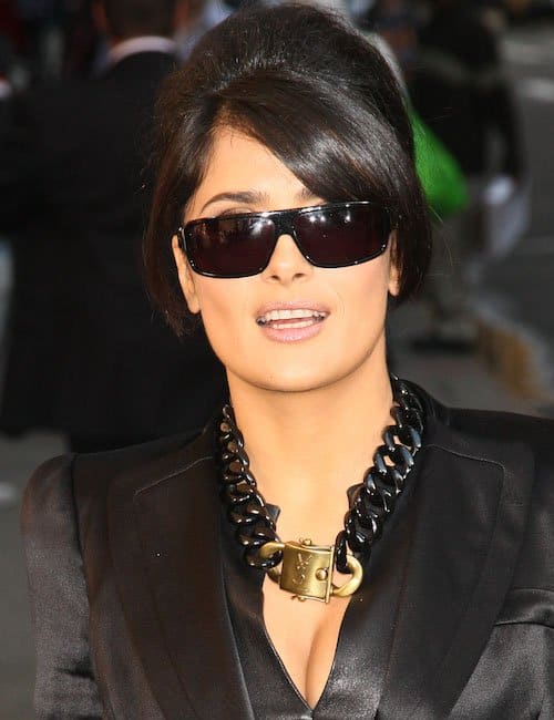 Salma Hayek's eye-catching Yves Saint Laurent necklace, featuring a distinctive gold turnlock pendant