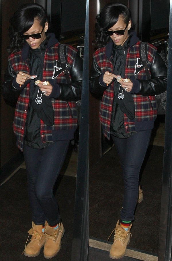 Rihanna was spotted exiting her London hotel on November 28, 2012, stylishly donning a Joyrich Freshman varsity jacket in red/black, Ray-Ban Wayfarer sunglasses, Timberland boots, and a Pierre Hardy leopard-print suede backpack