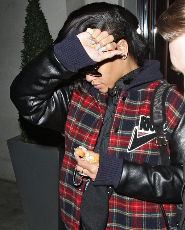 Captured in a moment of casual elegance, Rihanna dons Joyrich's 'Freshman' varsity jacket, adorned with the distinctive Rich swoosh logo, showcasing her unique blend of street style and luxury