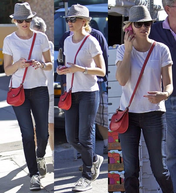 Elizabeth Banks exudes casual elegance in a crisp white T-shirt, classic denim, and comfortable sneakers for a relaxed farmers market day