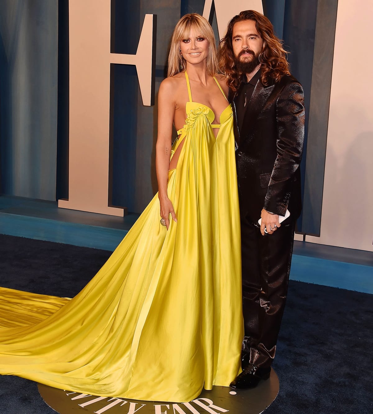 Heidi Klum in a yellow AZ Factory Spring 2022 gown with her husband Tom Kaulitz