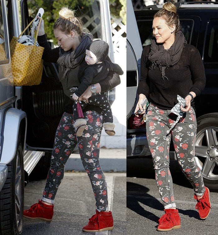 Hilary Duff wears floral-printed black jeans as she takes her son grocery shopping in Los Angeles