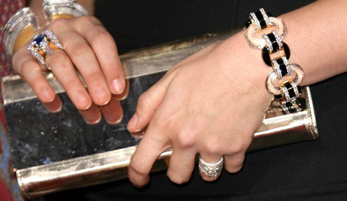 Hillary Scott showing off her jewelry and clutch