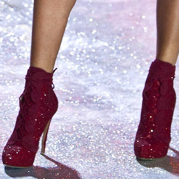 South African model Candice Swanepoel wears glittering red ankle boots