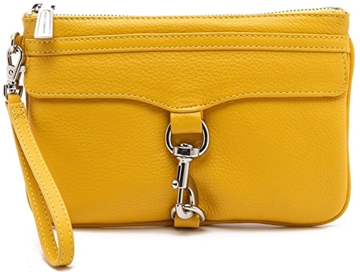 This petite leather clutch is detailed with polished hardware and a detachable wrist strap, and the zip opens to a print-lined interior