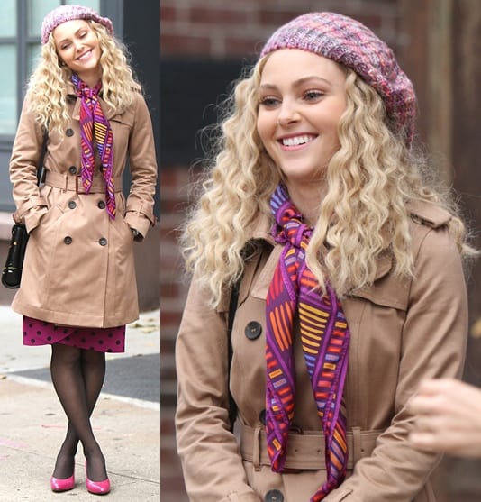 AnnaSophia Robb was dressed warmly in a trench coat, complemented by a playful pink hat